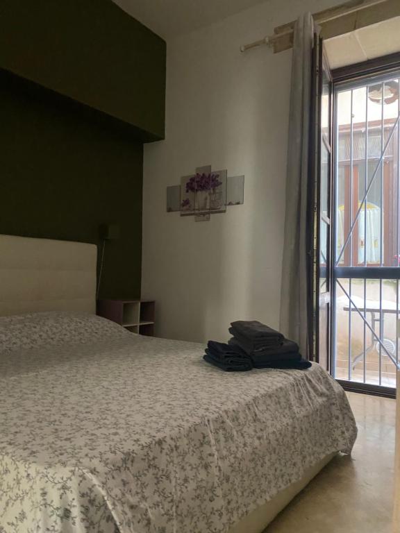 Postel nebo postele na pokoji v ubytování casa vacanze Maniace 80