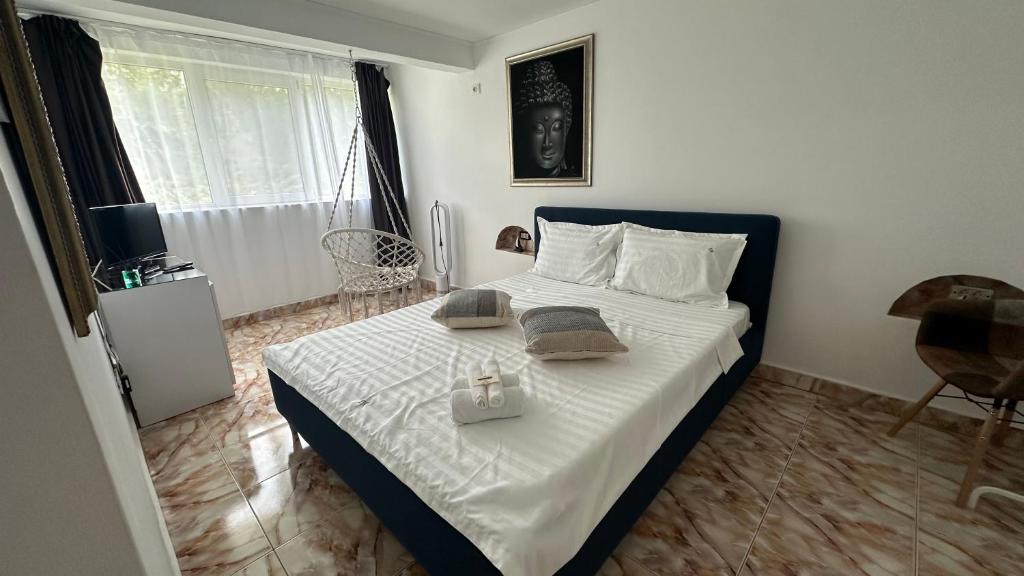 a bedroom with a bed with two dishes on it at Forest house in Eforie Nord