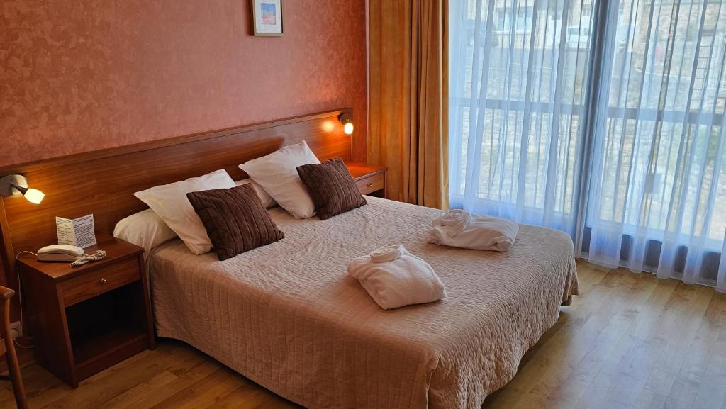 Voodi või voodid majutusasutuse Brit Hotel Du Ban toas