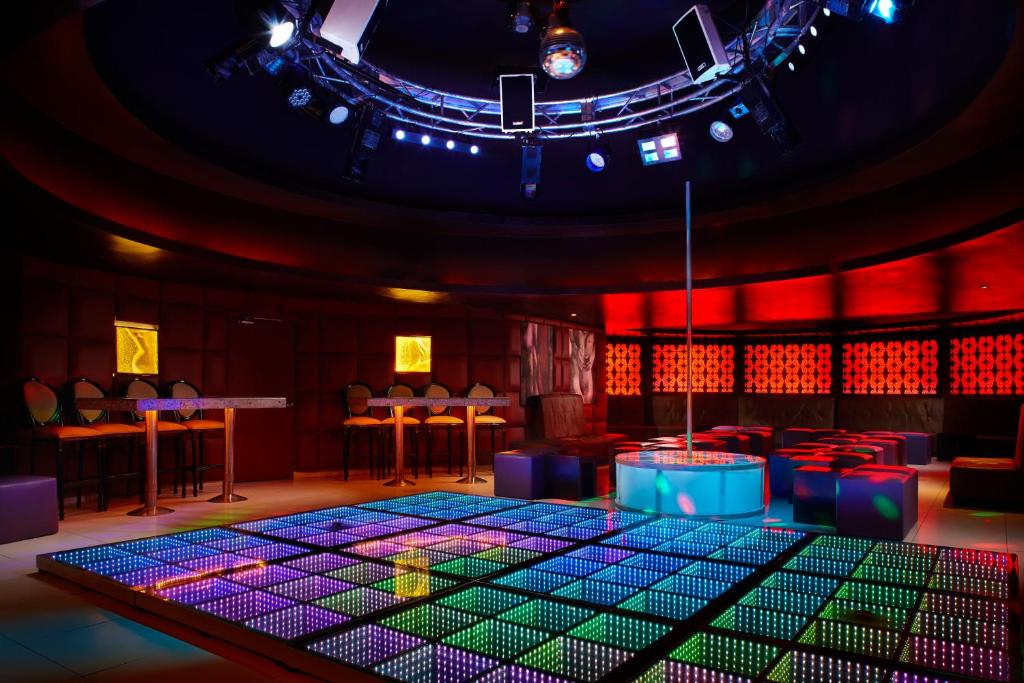 a room with a stage with a table and chairs at Desire Riviera Maya Resort All Inclusive - Couples Only in Puerto Morelos