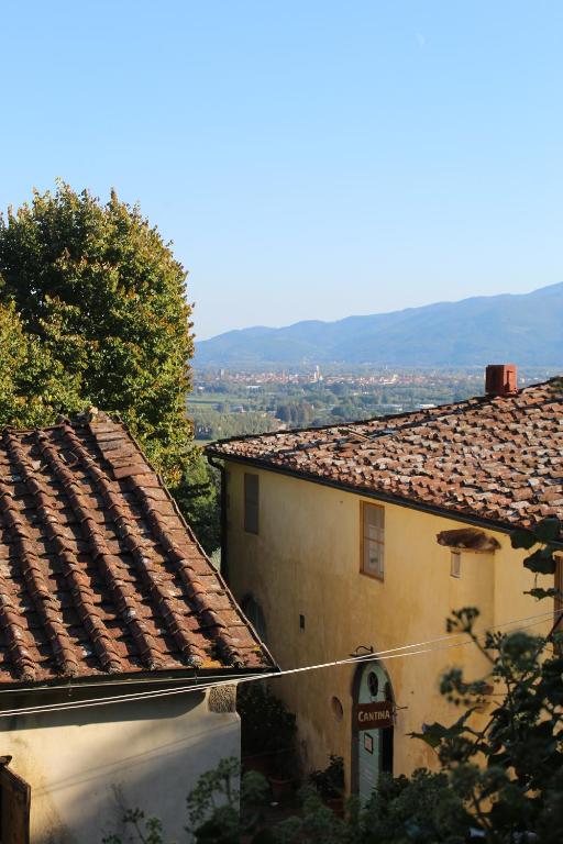 a building with a sign on the side of it at Azienda Agricola Fabbrica Di San Martino in Lucca
