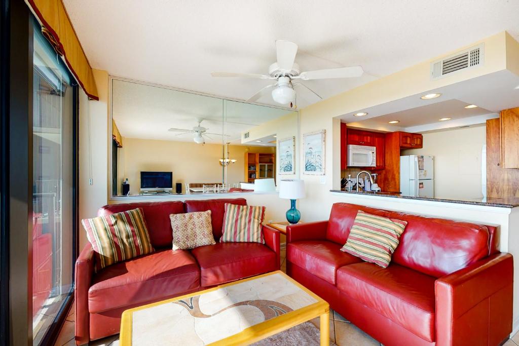 a living room with a red couch and a table at Sea Colony - 509 Dover House Rd. in Bethany Beach