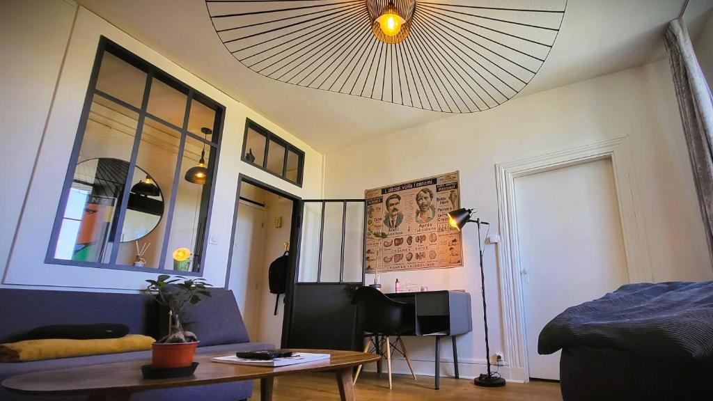 a living room with a couch and a table at Appartement du Fort Griffon in Besançon