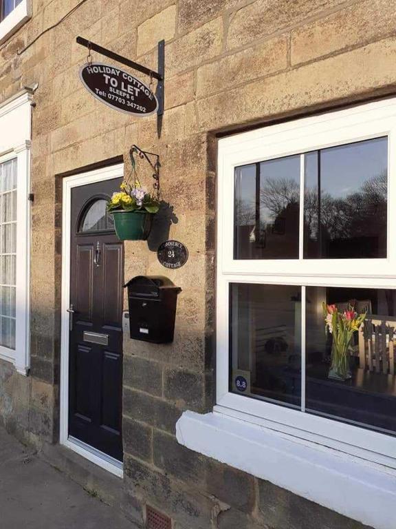 a brick building with a door and a window at Commerce Cottage Rooms in Ripley