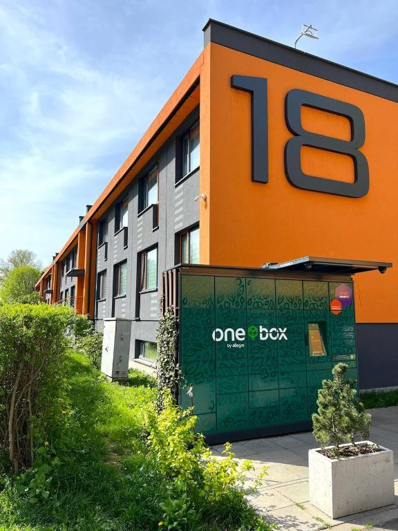 an orange building with a one box sign on it at The Park Suites in Warsaw