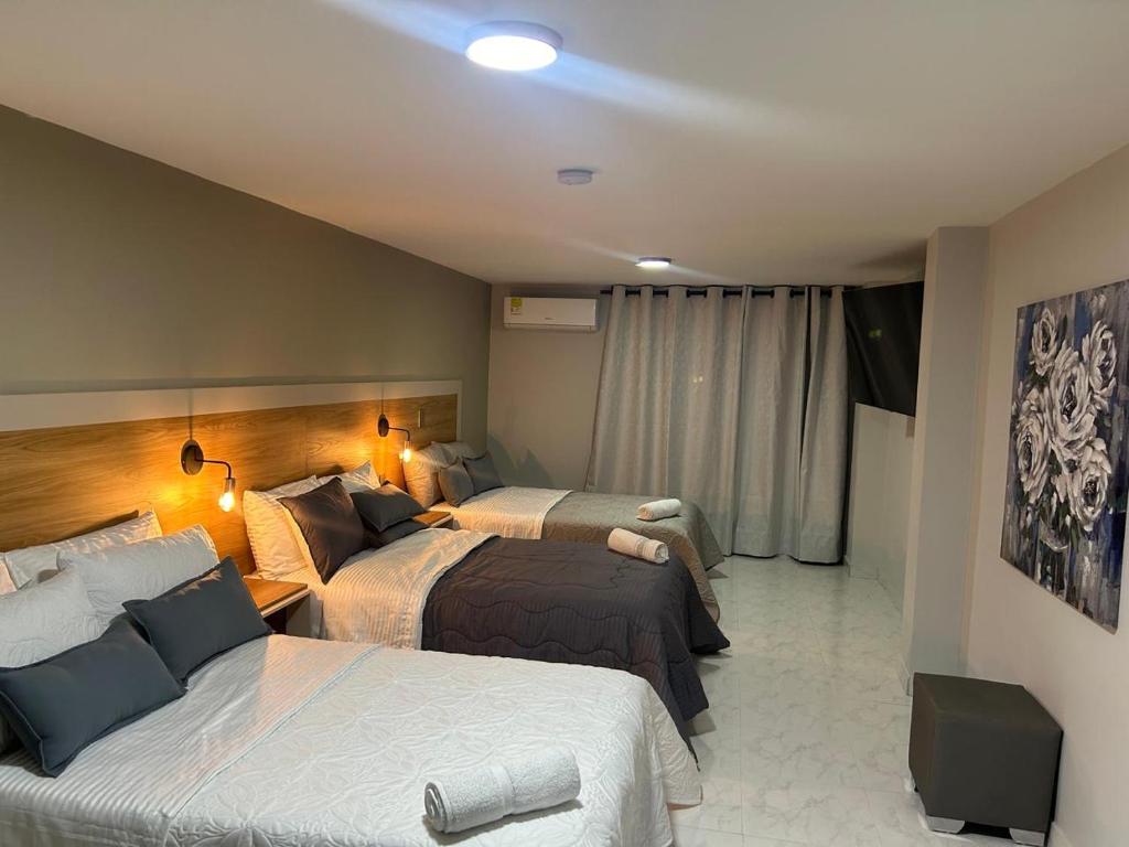 Postel nebo postele na pokoji v ubytování Provenza Medellin Hotel Boutique