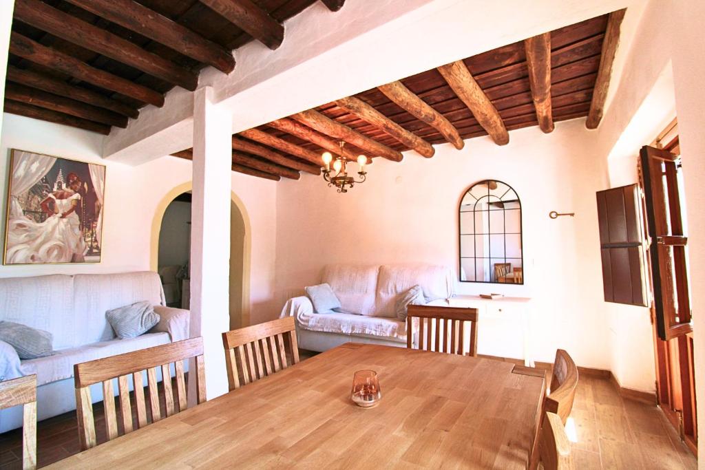 a living room with a table and a couch at El Pintaillo by SIERRA VIVA in Cortelazor