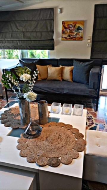 a living room with a table with cookies and a couch at COTTAGE villa in Káto Panayía