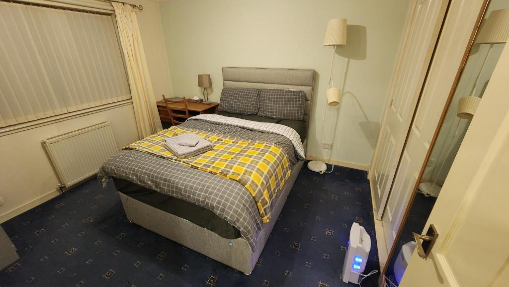 a small bedroom with a bed in a room at Lovely Home Stay 2 in Fife