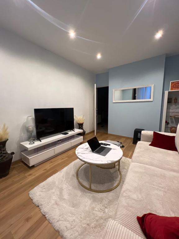 un salon avec un canapé et une table dans l'établissement Maison bleue, à Noisy-le-Sec