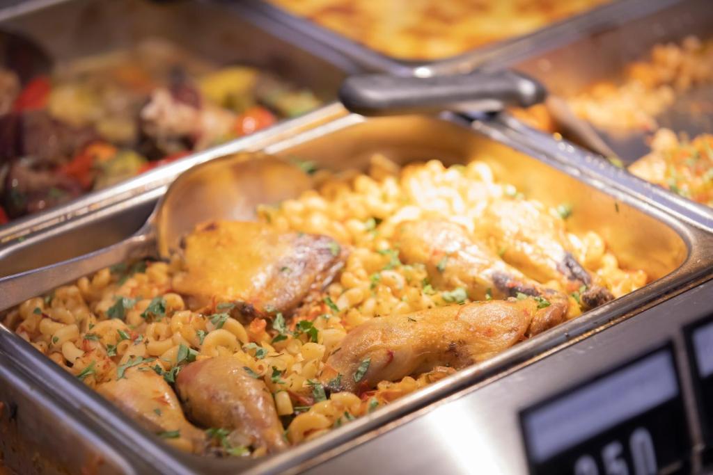 a tray of food with meat and rice at Resort Zdrava in Savër