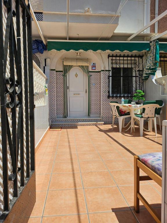 a room with a porch with a door and a table at Bungalow Gaviota con playa y terraza in Santa Pola