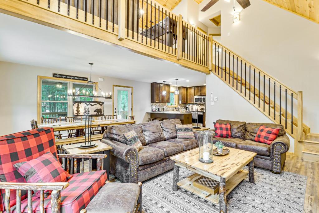 a living room with couches and a table at Forest Views and Hot Tub Poconos Cozy Cabin in Albrightsville