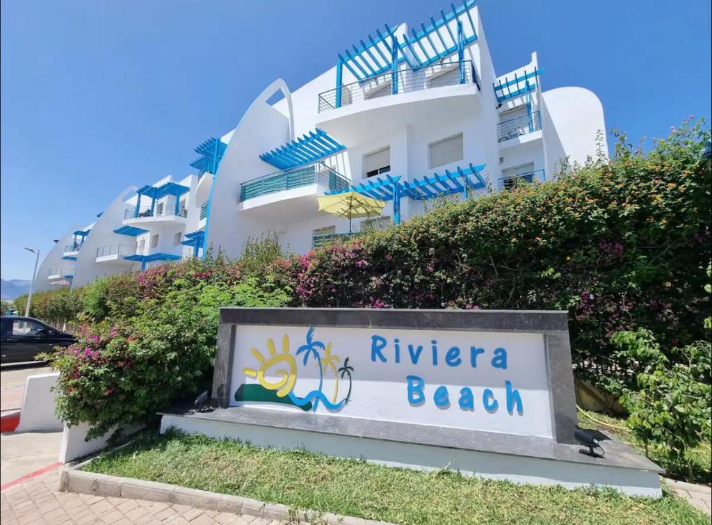 a sign in front of a building at Capo-martil Riviera residence three piscine in Cabo Negro