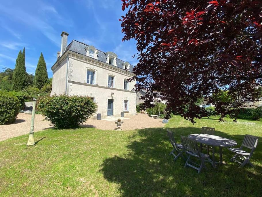 a house with a table and chairs in front of it at Maison de maître Azay Le Rideau - 8 personnes in Azay-le-Rideau