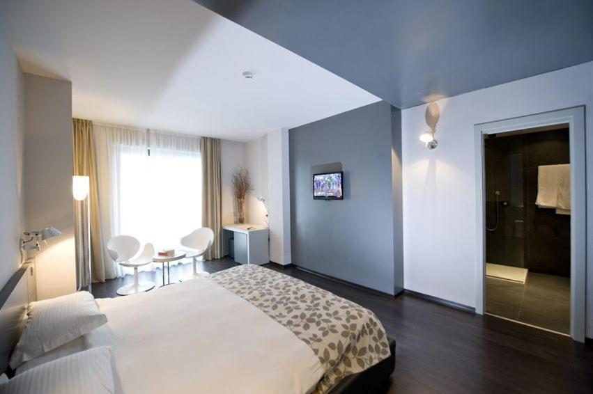 Postel nebo postele na pokoji v ubytování Piccolo Hotel