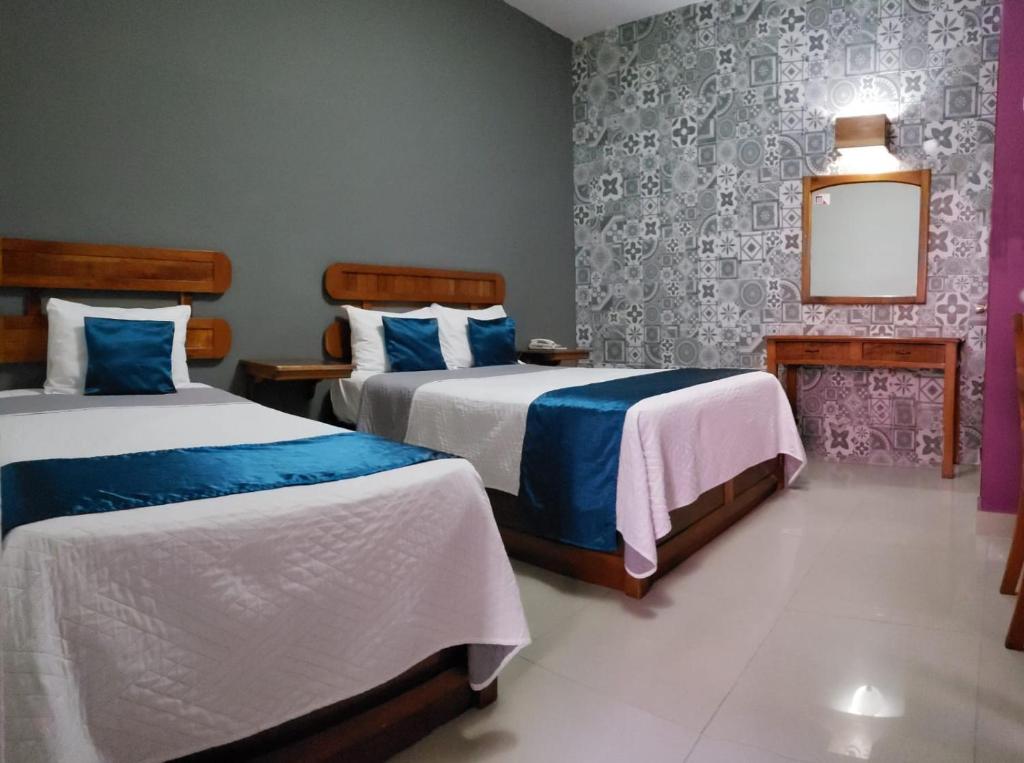 Postel nebo postele na pokoji v ubytování Hotel Pastora