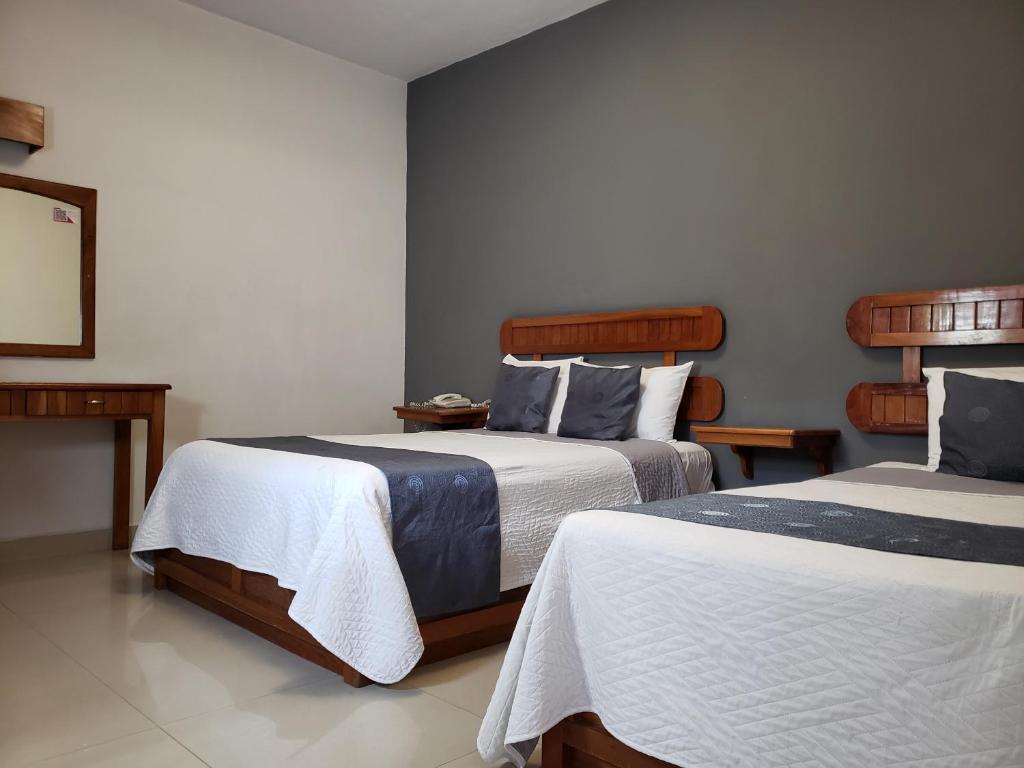 Postel nebo postele na pokoji v ubytování Hotel Pastora