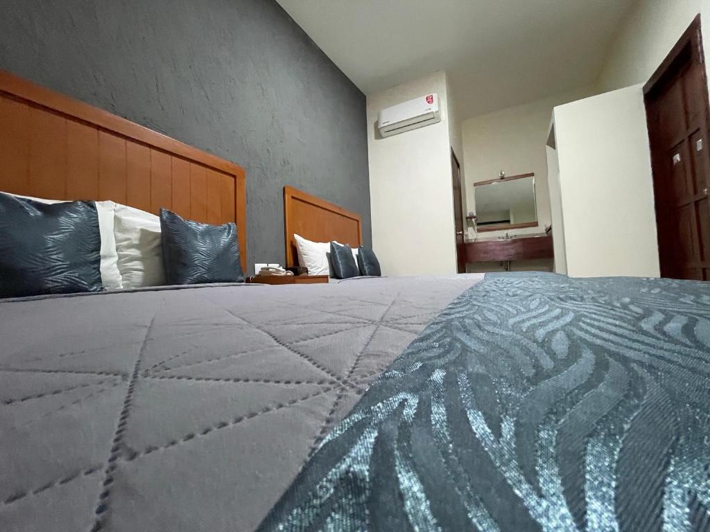 Postel nebo postele na pokoji v ubytování Hotel Pastora