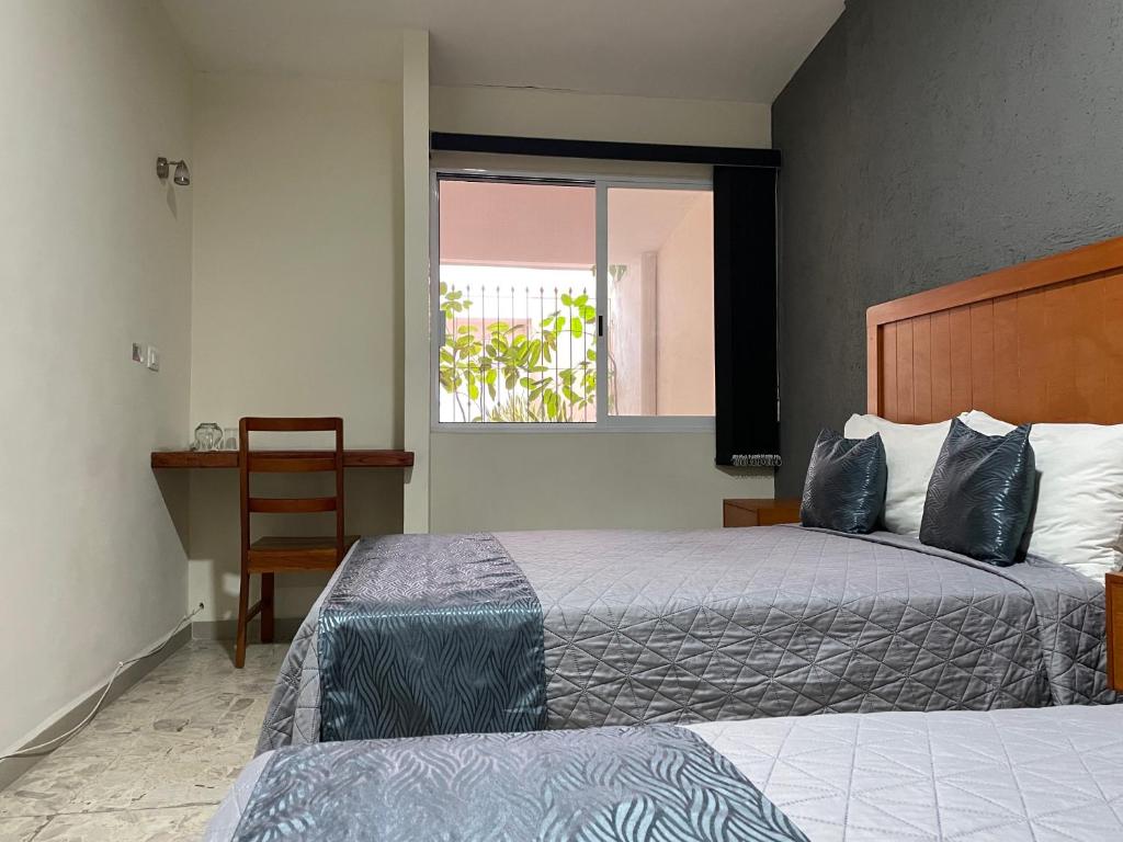 Postel nebo postele na pokoji v ubytování Hotel Pastora