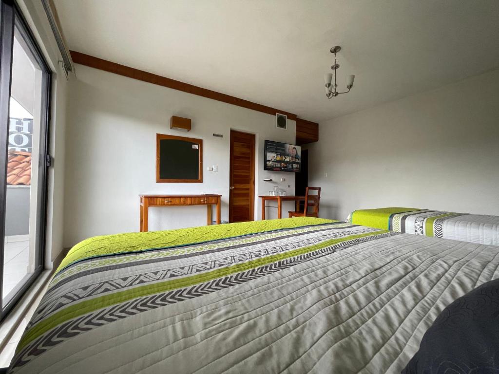 Postel nebo postele na pokoji v ubytování Hotel Pastora