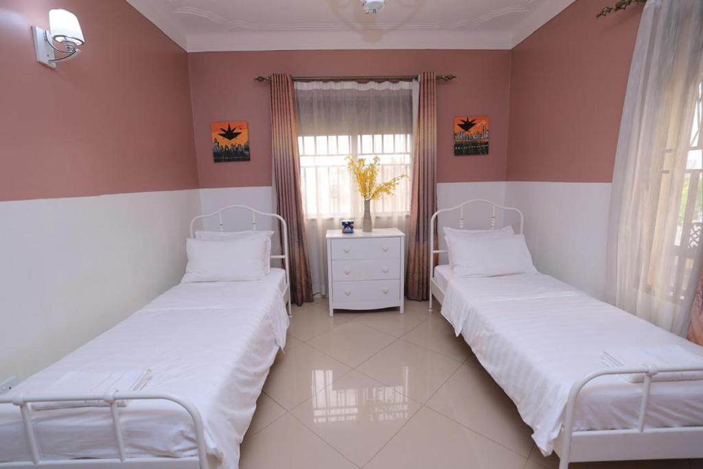 Postel nebo postele na pokoji v ubytování NCI Residence