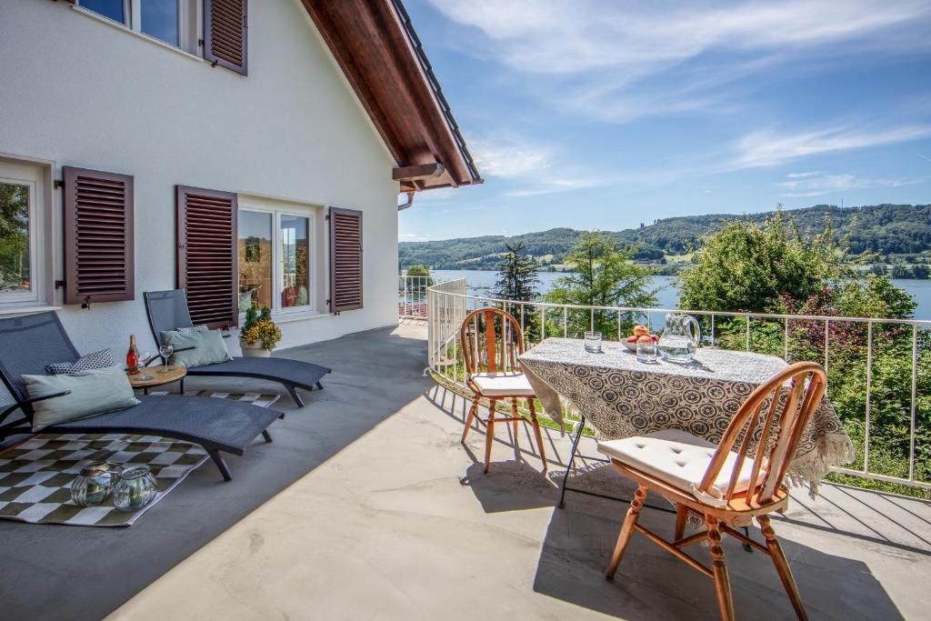 a patio with a table and chairs on a balcony at Haus am Rebberg in Öhningen