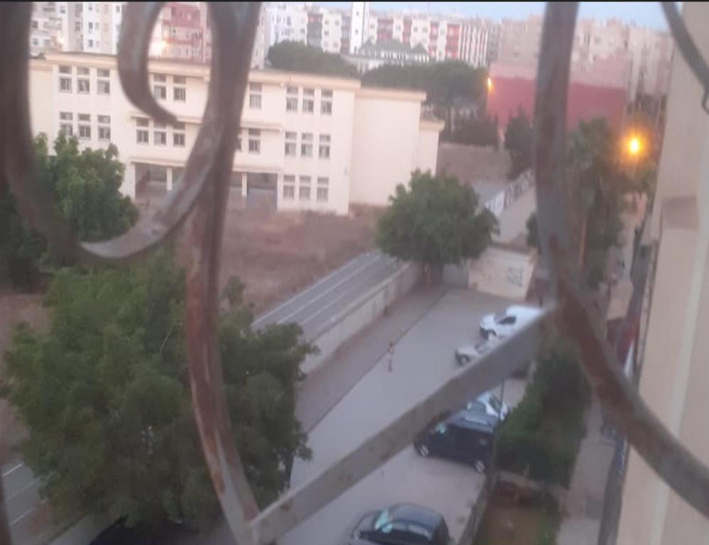 a view from a window of a parking lot at Al Makhazine House in Ksar el Kebir