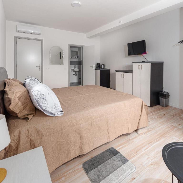 Postel nebo postele na pokoji v ubytování Fenix Apartments