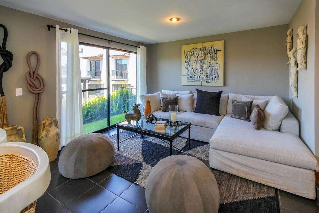 a living room with two couches and a table at Casa Serenna Un oasis en San Miguel de Allende in San Miguel de Allende