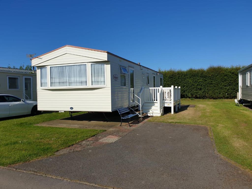 a tiny house is parked in a yard at Holiday Sea Caravan in Withernsea