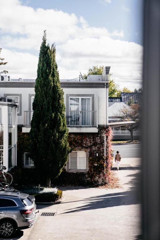 a dog is standing in front of a house at de Russie Boutique Hotel in Orange
