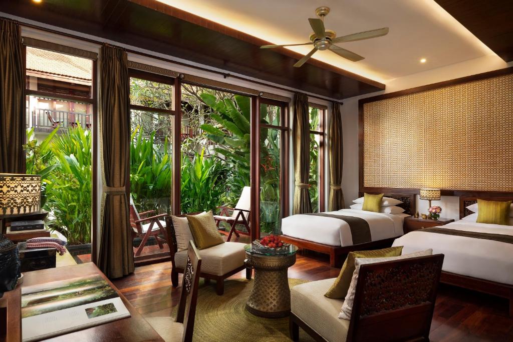 Postel nebo postele na pokoji v ubytování Anantara Angkor Resort