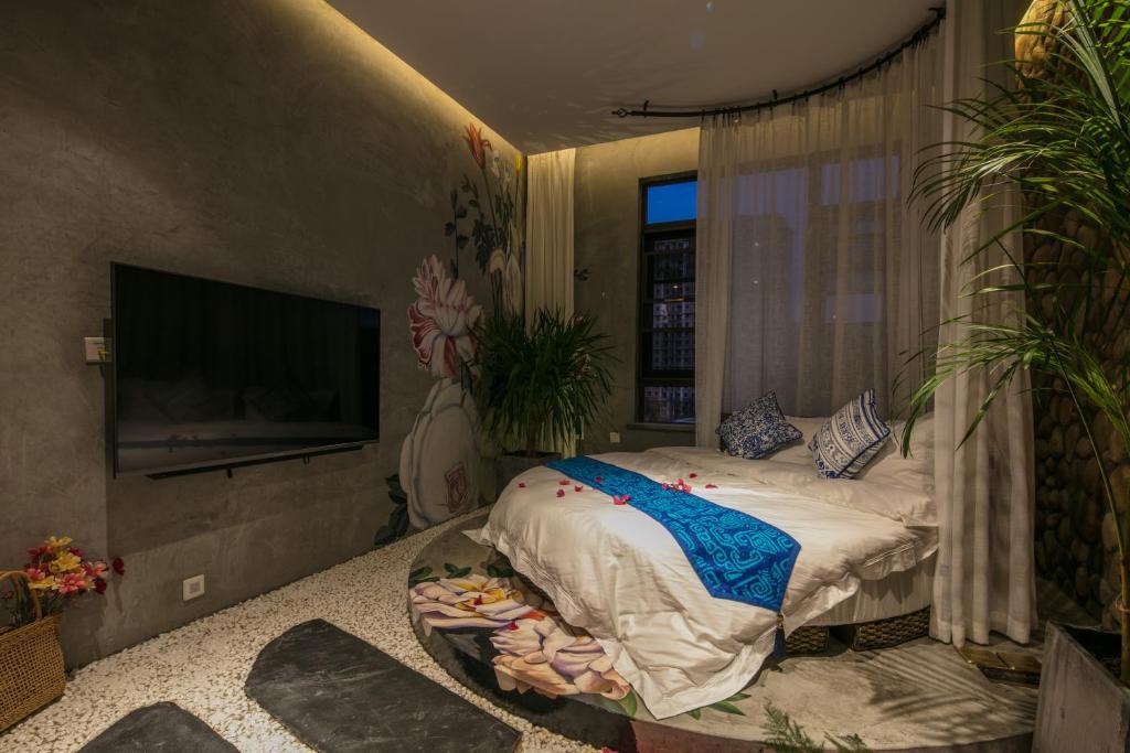 Postel nebo postele na pokoji v ubytování Bed and Breakfast B&B Qianxi 浅喜 SanYa