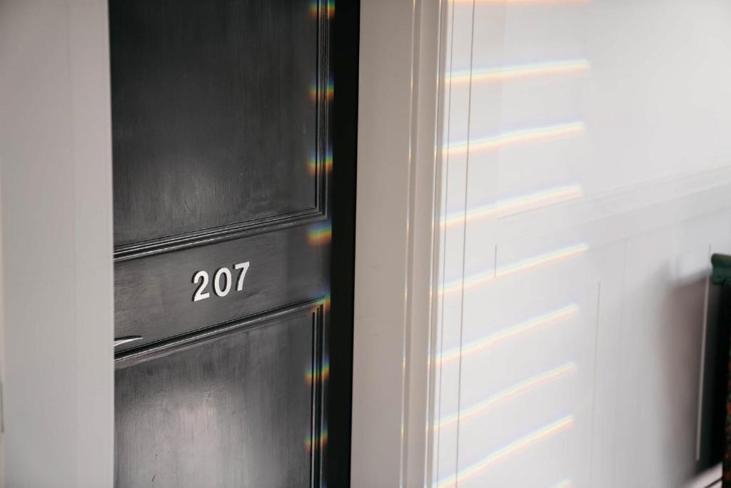 a door with the number on it next to a wall at de Russie Boutique Hotel in Orange