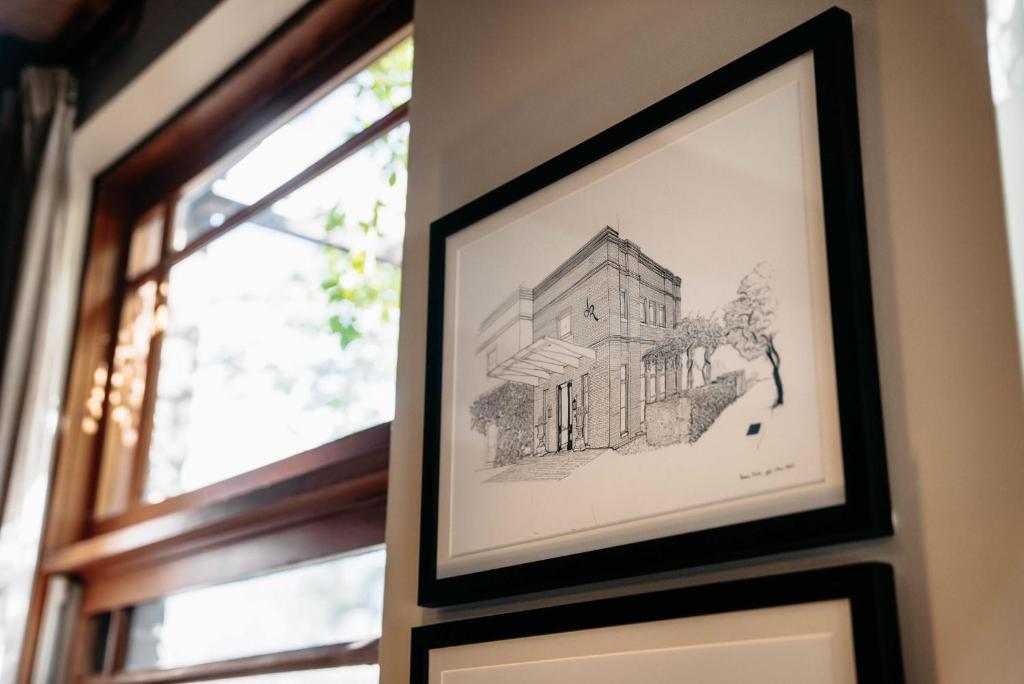 a drawing of a building on a wall next to a window at de Russie Boutique Hotel in Orange