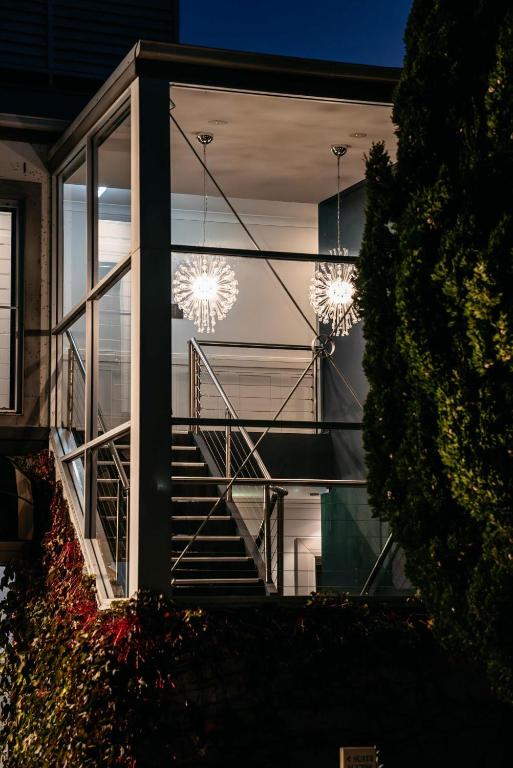a building with a staircase and chandeliers in the window at de Russie Boutique Hotel in Orange