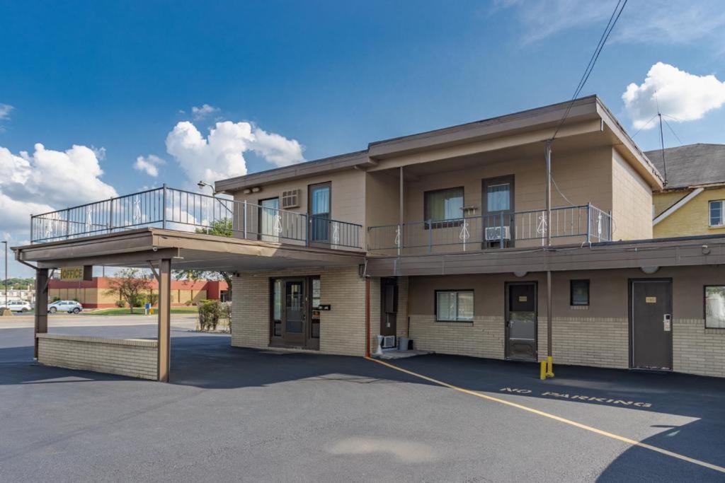 a building with a balcony on the side of it at DuBois Manor Motel in DuBois