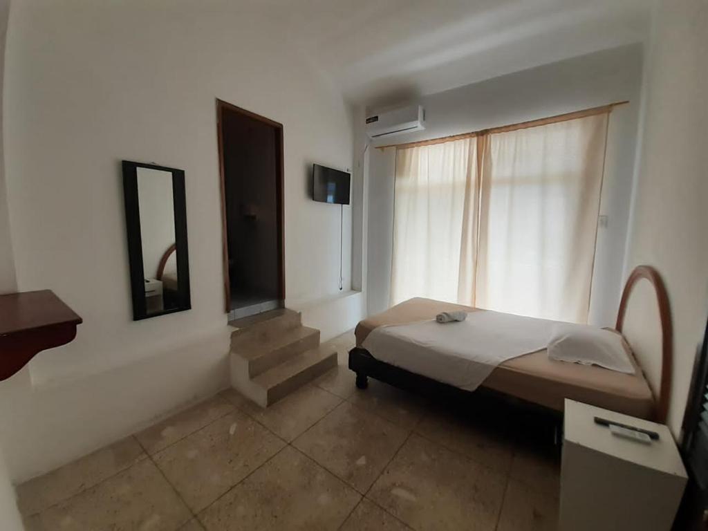 Postel nebo postele na pokoji v ubytování Hostal Tamara