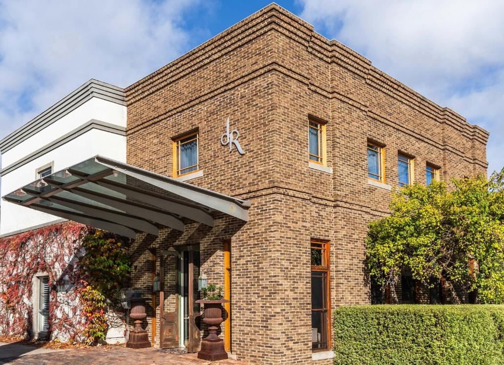 a brick building with an awning in front of it at de Russie Boutique Hotel in Orange
