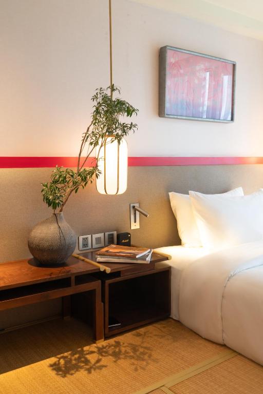 Postel nebo postele na pokoji v ubytování Suzu Saigon - A Boutique Hotel
