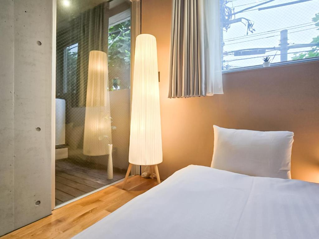 Postel nebo postele na pokoji v ubytování STAY ARI Apartment Hotel Shinjuku-Takadanobaba