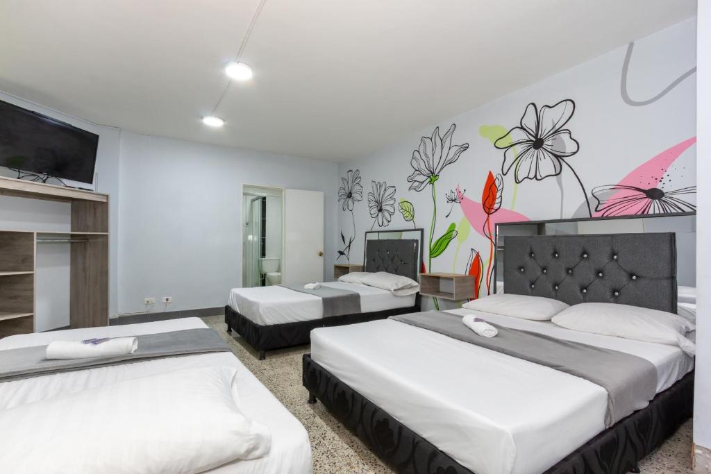 Postel nebo postele na pokoji v ubytování Hotel Guayacanes 70