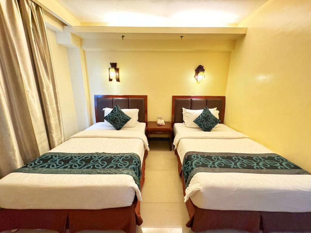 Postel nebo postele na pokoji v ubytování Golden Phoenix Hotel Boracay