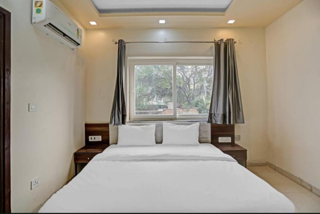 a bedroom with a large bed and a window at Expo View INN in Greater Noida