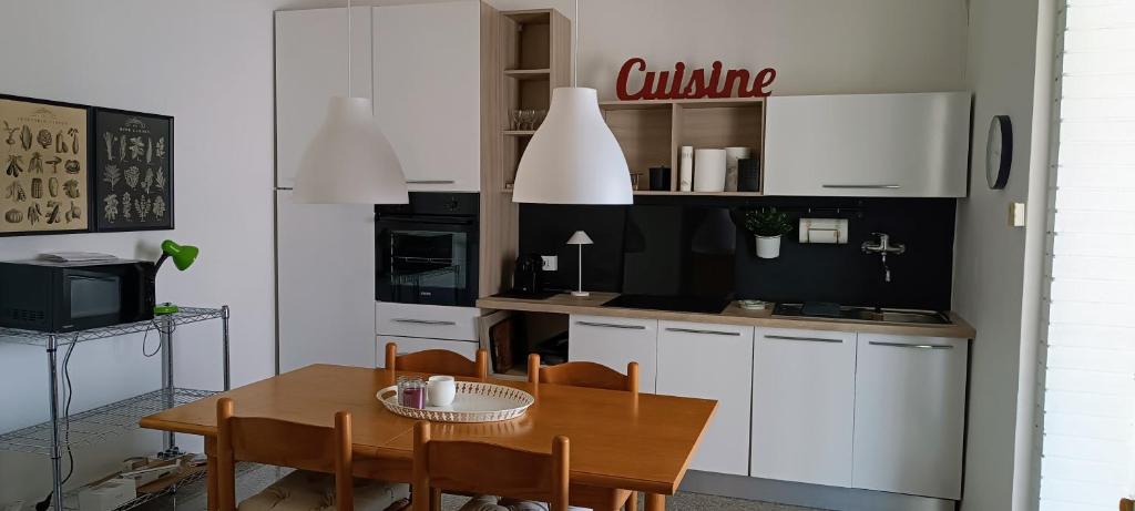 a kitchen with a table and a dining room at Il nido in Marina di Massa