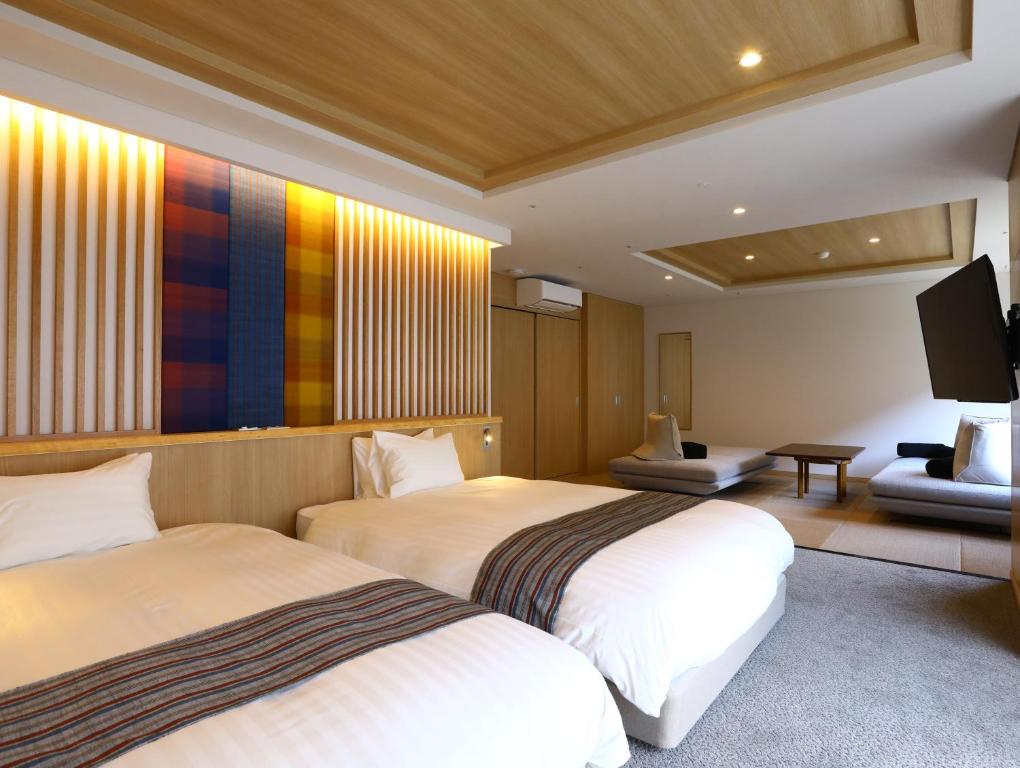 Postel nebo postele na pokoji v ubytování Saito Hotel