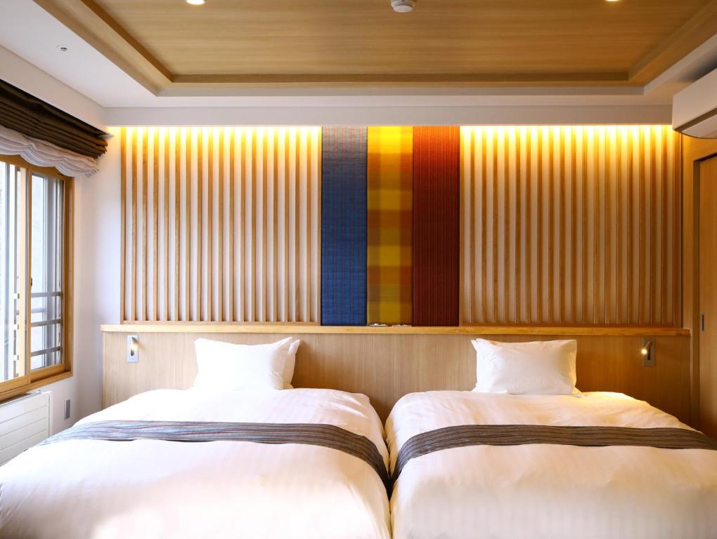 Postel nebo postele na pokoji v ubytování Saito Hotel