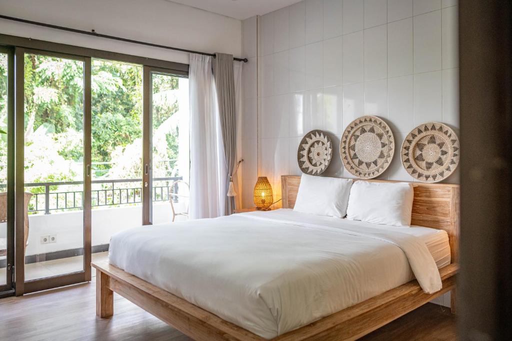 Postel nebo postele na pokoji v ubytování Gajahmina Guesthouse