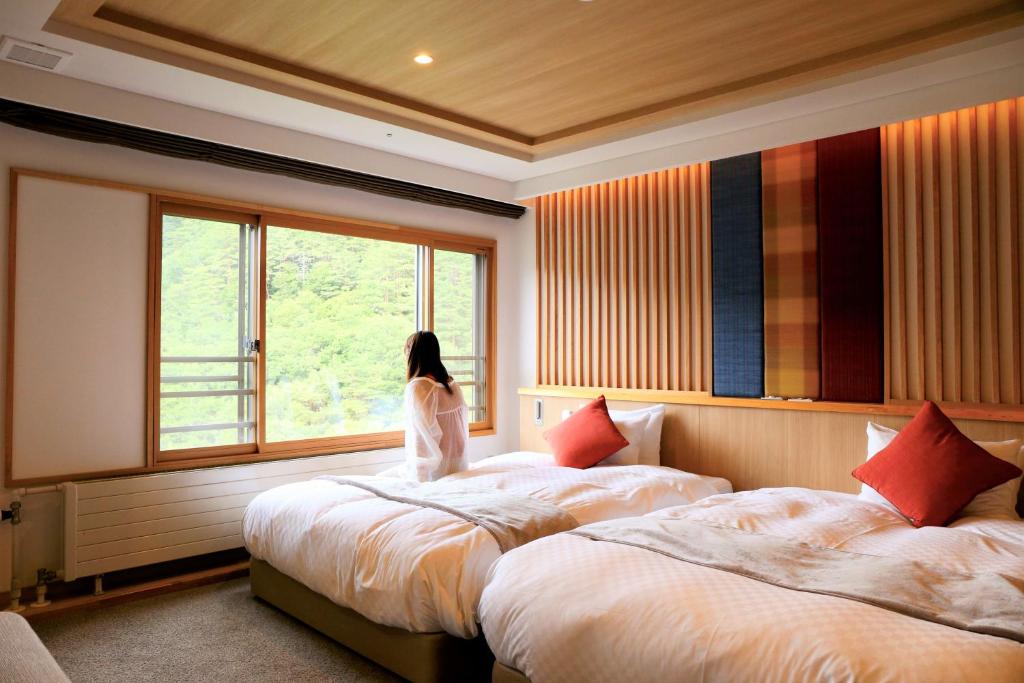Postel nebo postele na pokoji v ubytování Saito Hotel